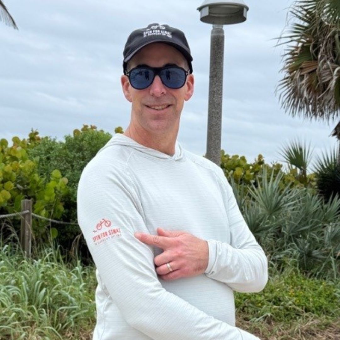 Man pointing at his arm to showcase event logo