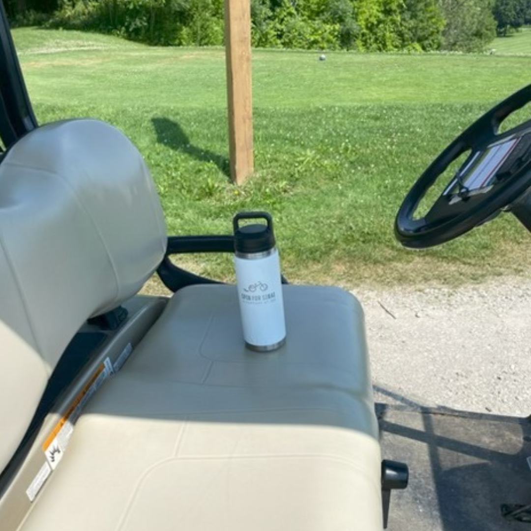 Water bottle resting on the seat of a golf cart