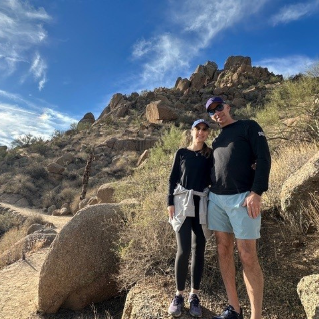 couple posing for photo with mountain behind